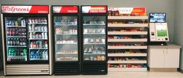 A micro market kiosk with snacks and drinks with a checkout terminal