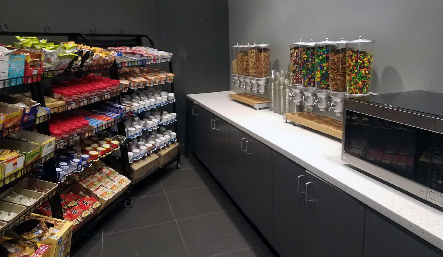 Office pantry setup with organized snacks and beverages